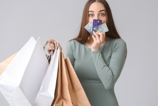 Woman holding shopping bags kissing cards