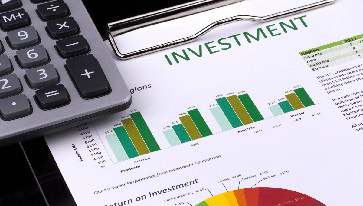calculator on top of an investment report
