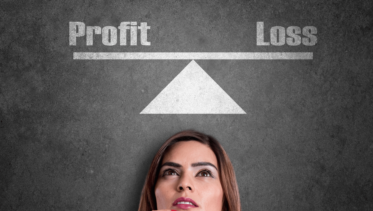 woman looking up a seesaw with the text profit and loss set on either end