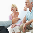 elderly couple chatting with a man