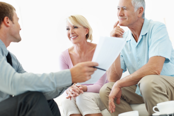 elderly couple chatting with a man