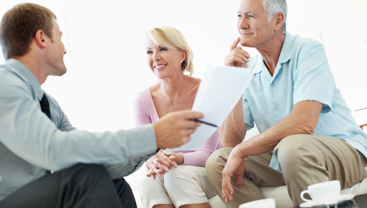 elderly couple chatting with a man