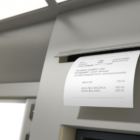 A withdrawal receipt coming out of an ATM