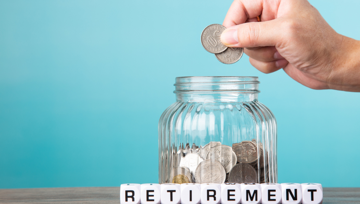 placing coins into a money jar with retirement written underneath it