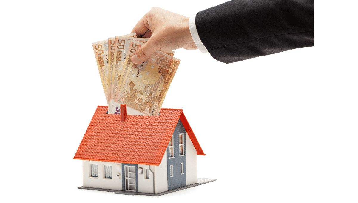 Investing in a home money placed inside a money box shaped like a house