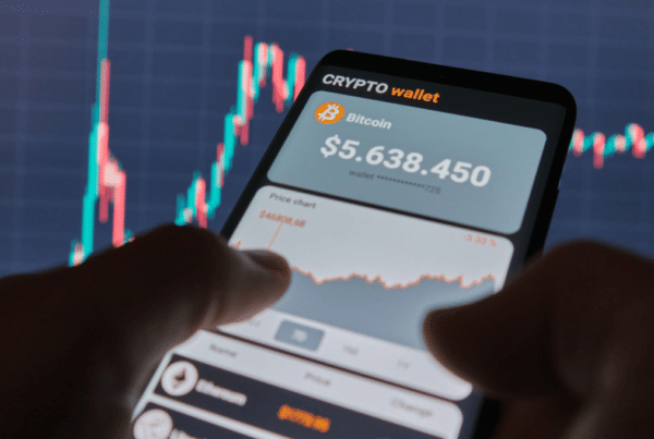 Two hands holding a phone with a crypto wallet app open.